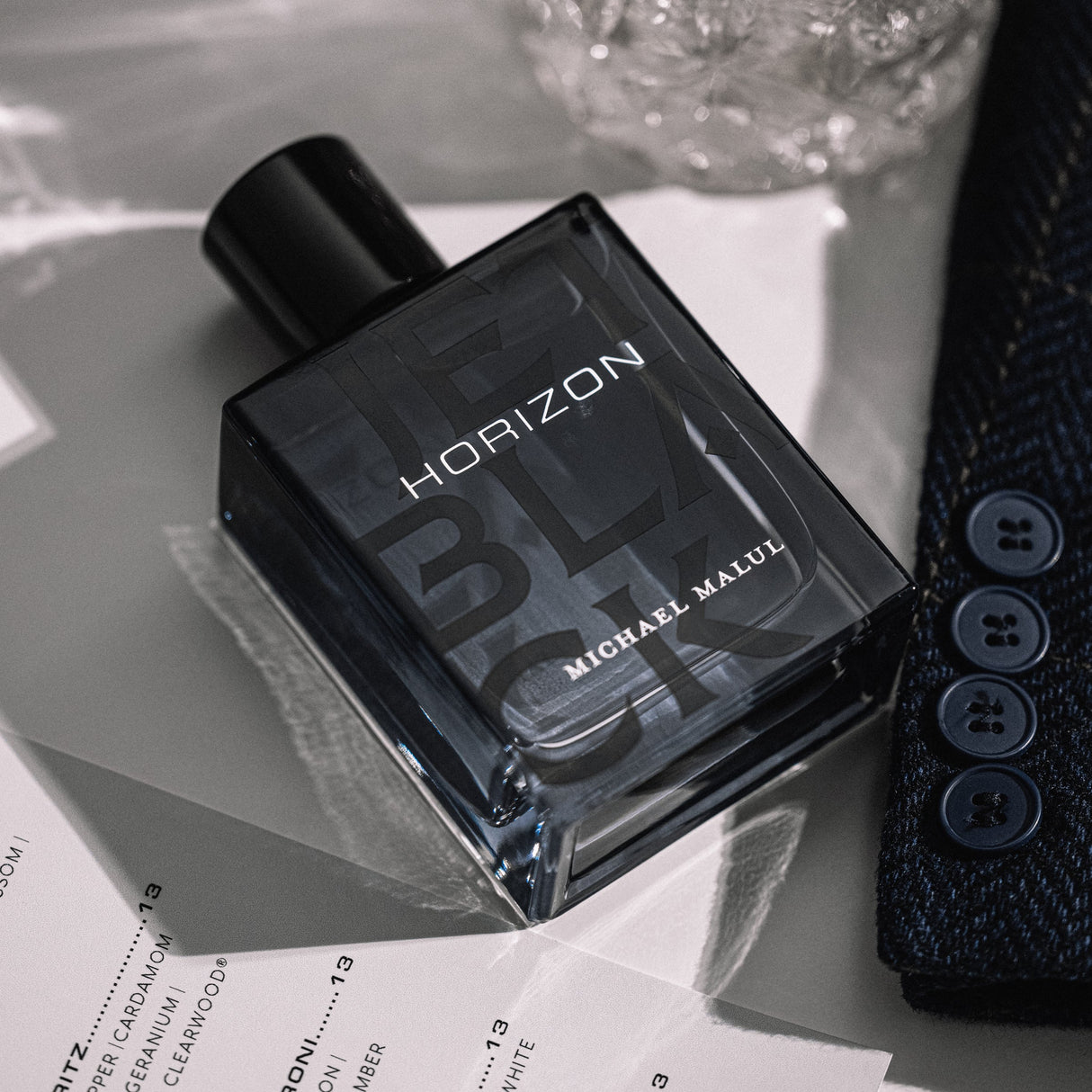 Michael Malul Jet Black Horizon Eau de Parfum styled against a dark city-night backdrop