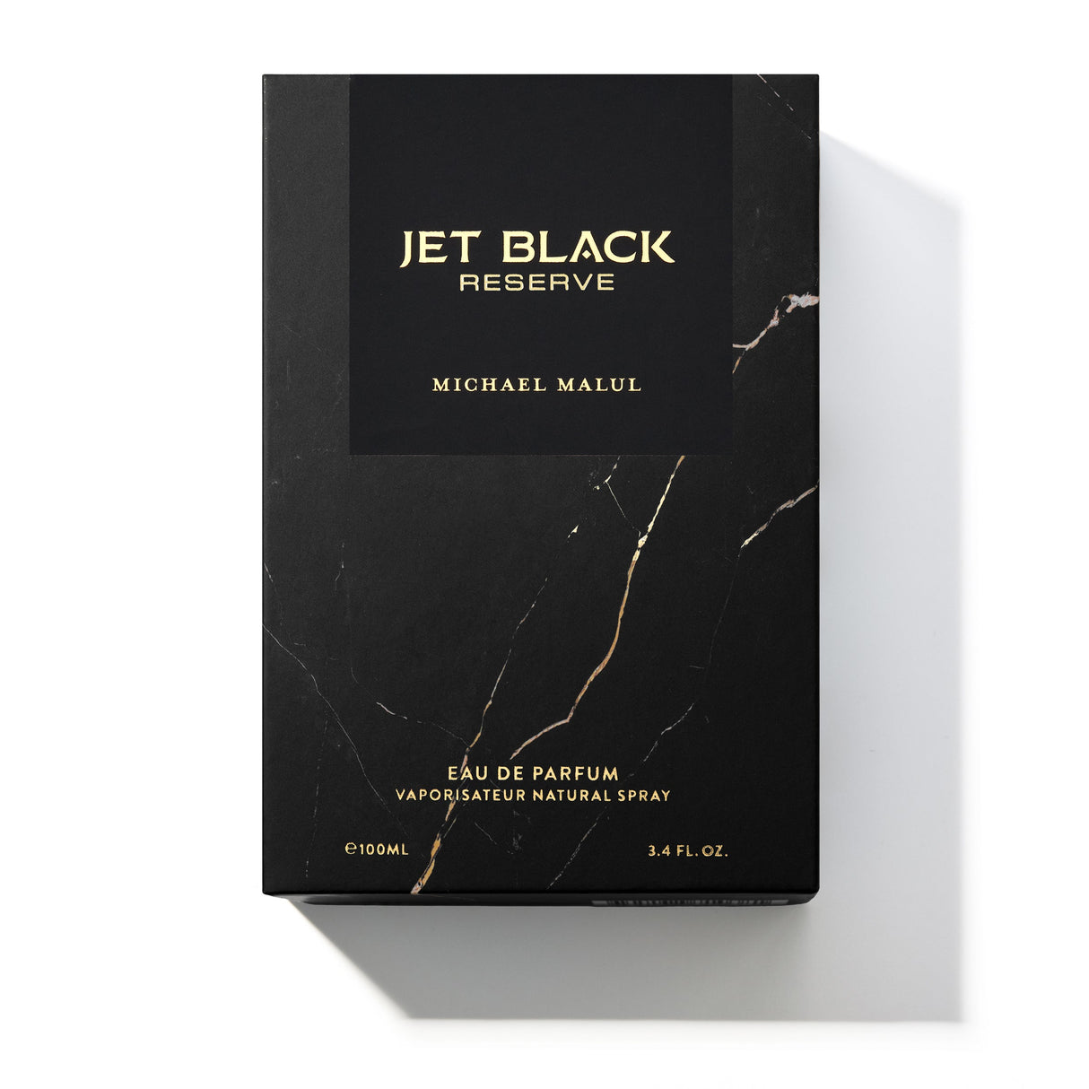 Michael Malul Jet Black Reserve cologne bottle shown beside its outer packaging box