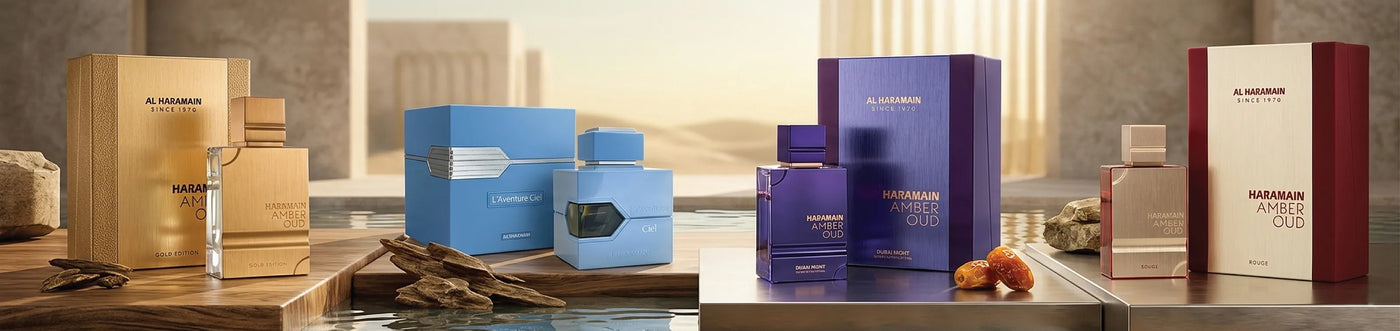 Al Haramain Perfume collection in a marble bathroom with light shining from the window. Amber Oud, L'Aventure Ciel, Amber Oud Dubai Night, Amber Our Rogue