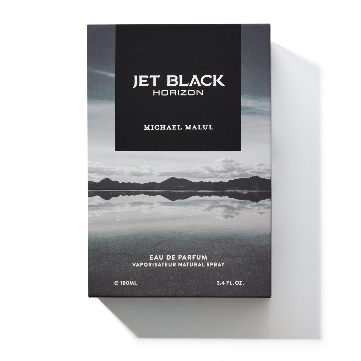 Michael Malul Jet Black Horizon cologne bottle shown beside its outer packaging box