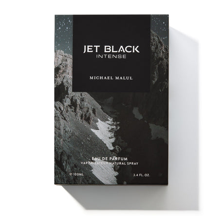 Michael Malul Jet Black Intense cologne bottle shown beside its black outer packaging box