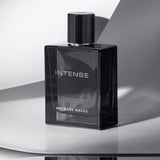 Michael Malul Jet Black Intense Eau de Parfum styled on a dark surface with moody lighting