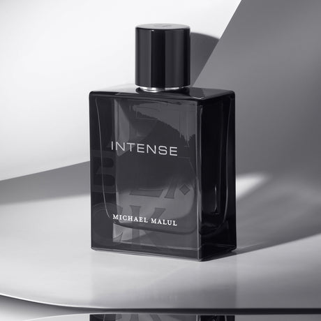 Michael Malul Jet Black Intense Eau de Parfum styled on a dark surface with moody lighting