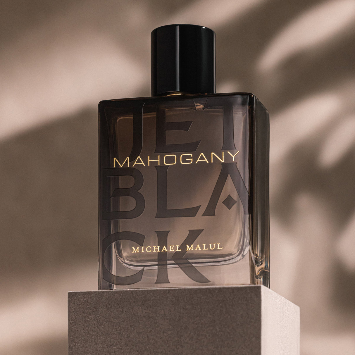Michael Malul Jet Black Mahogany fragrance notes: black pepper, cardamom, violet leaf, vetiver and cedarwood