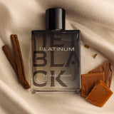 Michael Malul Jet Black Platinum Eau de Parfum styled on a dark surface with warm lighting