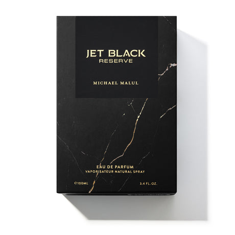 Michael Malul Jet Black Reserve cologne bottle shown beside its outer packaging box