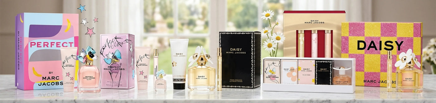 Collection of Marc Jacobs perfume bottles and packaging on a white marble surface with a blurred window background. Perfect, Daisy